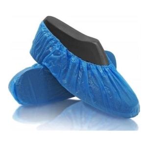 Blue disposable shoe covers with elastic cuffs, resting on a reflective white surface.