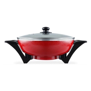 Red enamel skillet with a glass lid and black angled side handles.