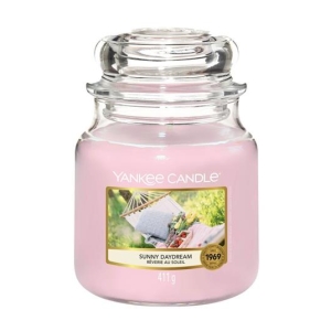 Pink Yankee Candle jar candle with a label reading Sunny Daydream and a small outdoor scene on the front label, 411 g, pink wax.