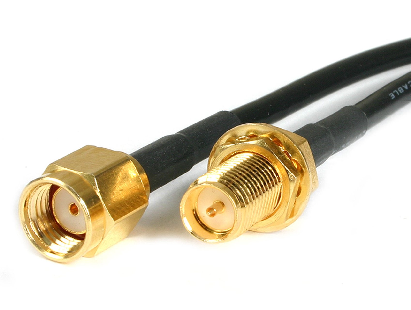 790406 - Computech-Solutions Close-up of gold-plated RF coax connectors (SMA) on black cables against a white background.