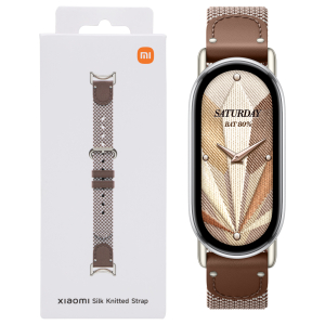 BHR07YJGL_Xiaomi-Smart-Band-10-Knitted-Silk-Strap-Feather-Brown_wr_01bjpg - Computech-Solutions Xiaomi Silk Knitted Strap packaging next to a smartwatch with a brown knitted strap
