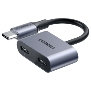 Close-up of a UGREEN USB-C hub: silver body, black cable, USB-C male plug, and two USB-C female ports visible.