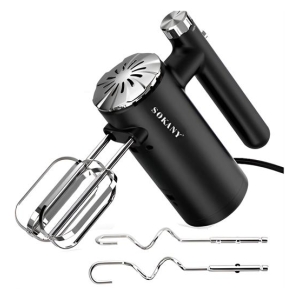 Black handheld electric mixer with stainless steel beaters attached to the sides and extra attachments nearby