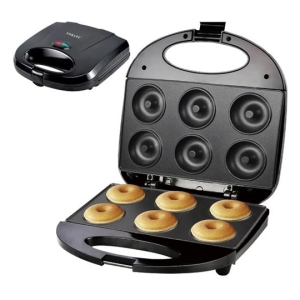 Electric donut maker with six donut molds open, six golden-brown donuts ready in the bottom plate; a separate sandwich/toaster appliance sits nearby.
