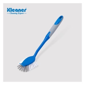 Blue and gray handheld scrubbing brush with white bristles on a light background; Kleaner Cleaning Expert logo top-left.