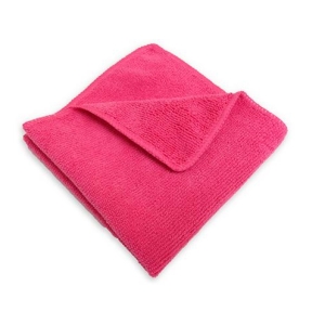 Bright pink bath towel neatly folded on a white background.