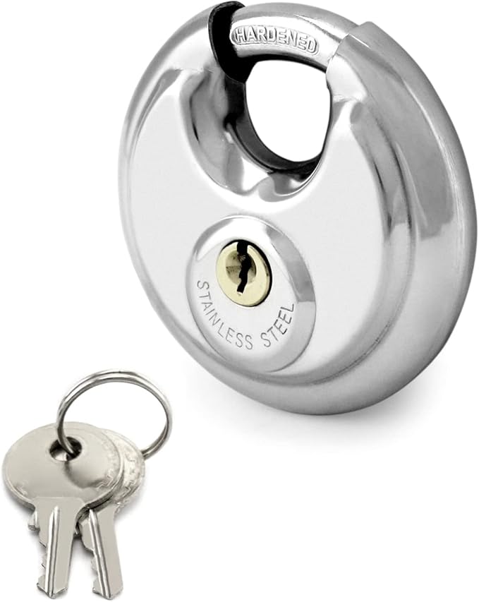 Chrome round padlock with a pair of keys on a ring beside it.
