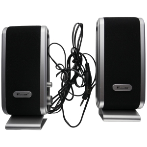 Pair of black desktop speakers with silver trim and tangled cables between them.
