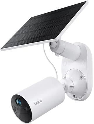 TAPOC410KIT ComputechSolutions White outdoor security camera with a mounted solar panel on the wall. The solar panel charges the camera system as part of a solar-powered setup.