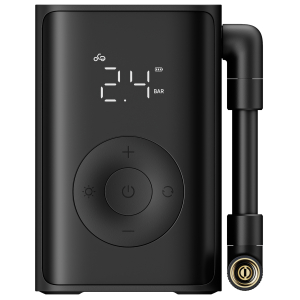 Close-up of a black portable air pump with a digital display reading 2.4 BAR, bike icon, and a circular control pad; hose connector on the right.