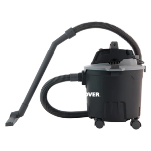 Black canister vacuum with a flexible hose and floor nozzle attached, on wheels for mobility