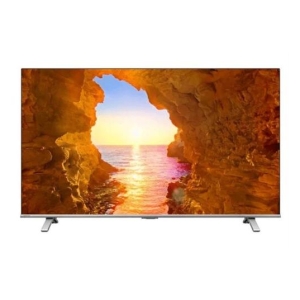 TV screen showing a sunset over the sea framed by rocky cave walls