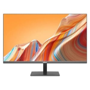Flat-screen computer monitor on a stand displaying a vibrant orange and multicolor abstract mountain wallpaper.