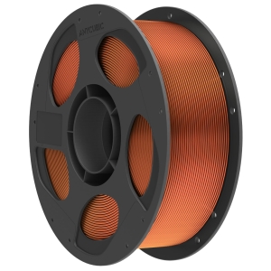 Large black spool with orange 3D printer filament wound around it, showing multiple windings and central hub holes.