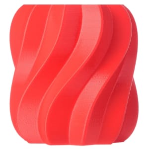 Roll of red satin ribbon with multiple curled loops on a white background