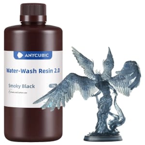 Brown bottle of Anycubic Water-Wash Resin 2.0 in Smoky Black (1 kg) shown next to a blue winged statue.